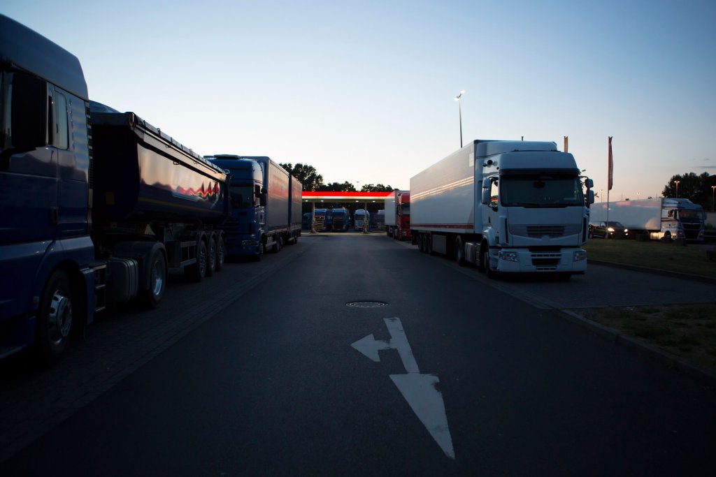 Lorries parked at a rest area at dusk.