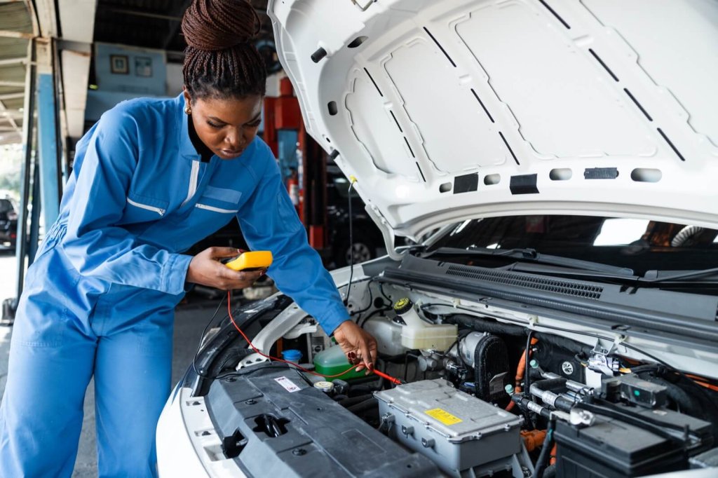 A technician testing the engine bay of an electric van.