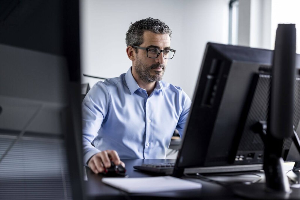 Administrator working at a computer in an office.